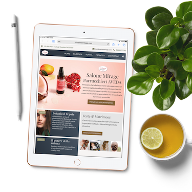 An iPad displaying a lovely salon website built with Foundation. The iPad is next to a plant with lemon tee.